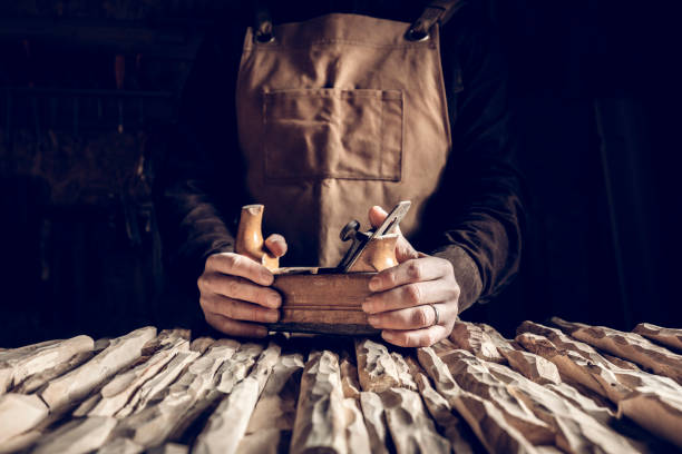detail of hands holding vintage hand planer