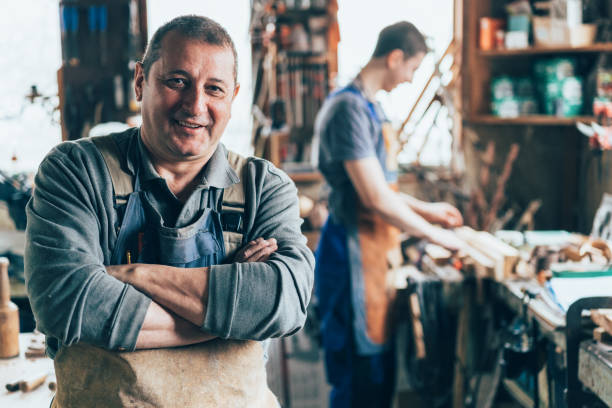 Portrait of Craftsman crossed arms in carpentry workshop